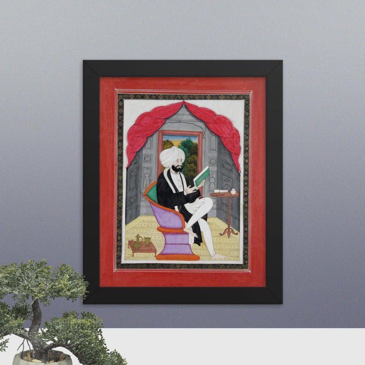 A Sikh Sardar reading from a book, seated in front of a window - Framed Print - SRI ASDHUJ
