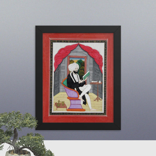 A Sikh Sardar reading from a book, seated in front of a window - Framed Print - SRI ASDHUJ
